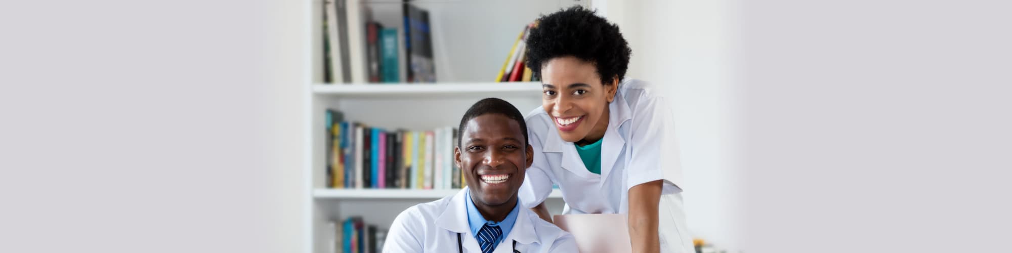 African american doctor with nurse looking at camera